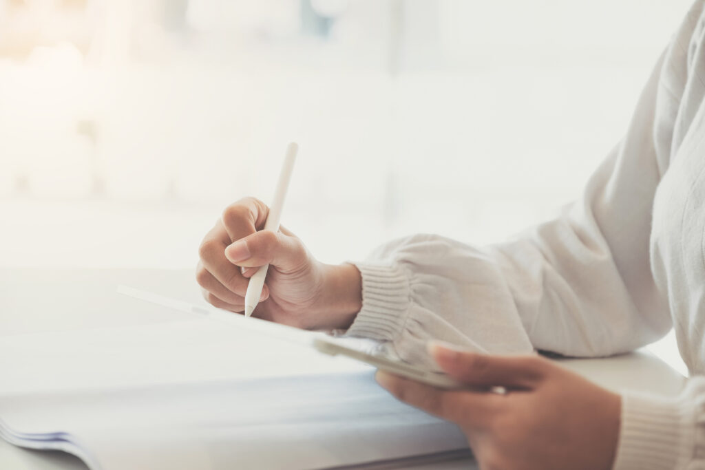 Woman holding a pen writing